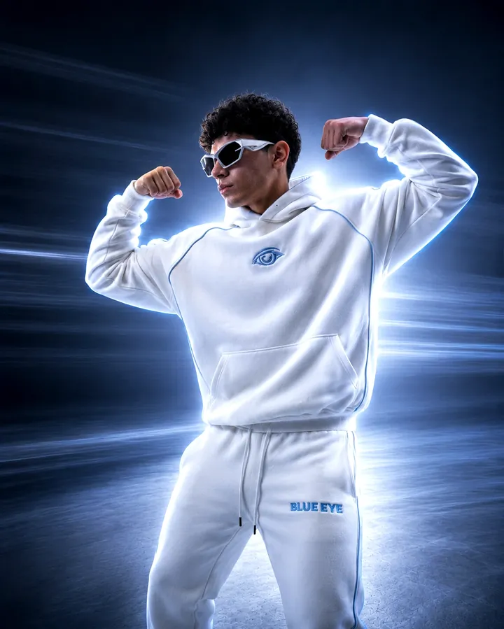 A flexed pose in a white hoodie and sunglasses against a background of light streaks.